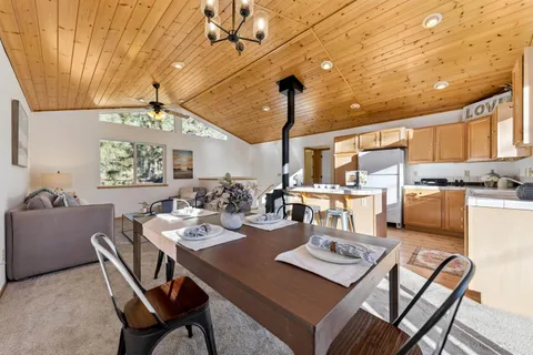a kitchen with kitchen island granite countertop a sink cabinets and window