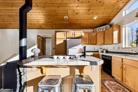 a kitchen with stainless steel appliances granite countertop wooden cabinets a sink and dishwasher
