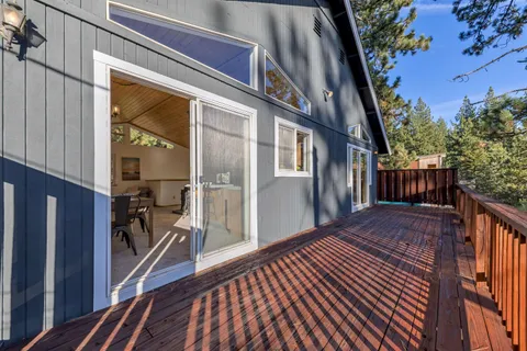 a view of a porch with wooden floor and furniture