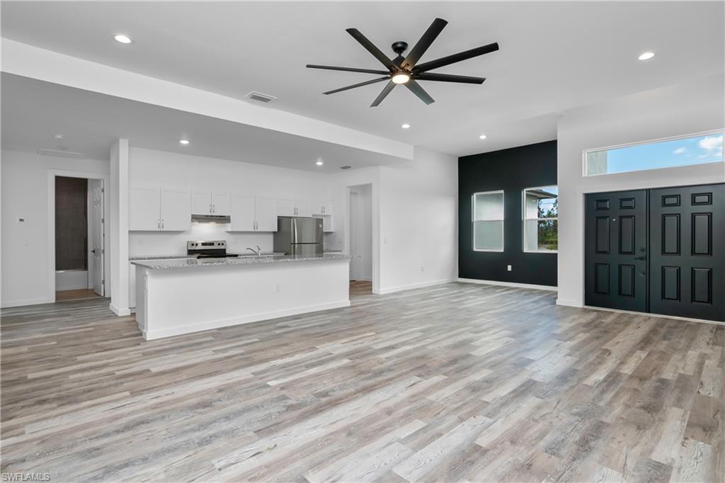 1515 Nelson Road North Cape Coral, FL 33993 - Photo 11 of 38 a view of kitchen with cabinets and refrigerator