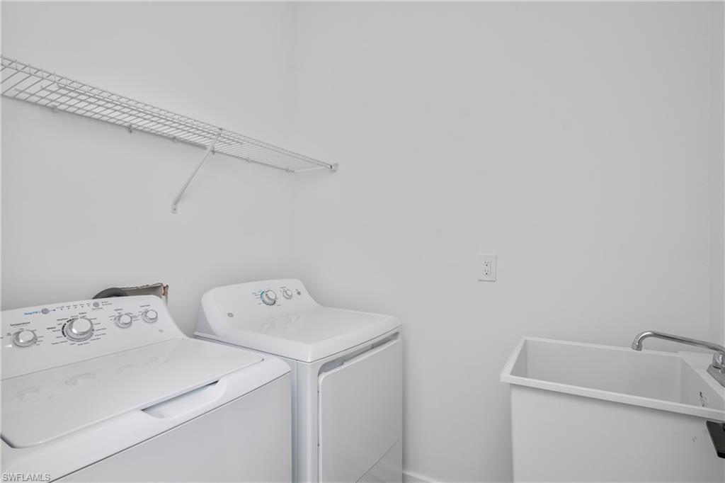1515 Nelson Road North Cape Coral, FL 33993 - Photo 19 of 38 a utility room with dryer and washer