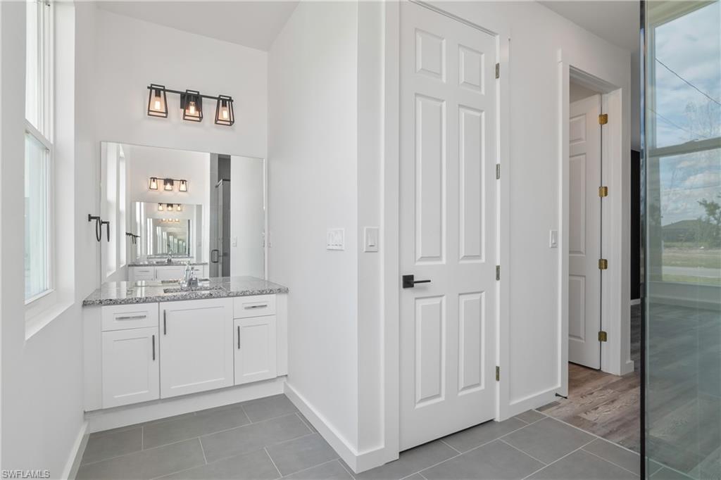 1515 Nelson Road North Cape Coral, FL 33993 - Photo 25 of 38 a bathroom with a sink and a mirror