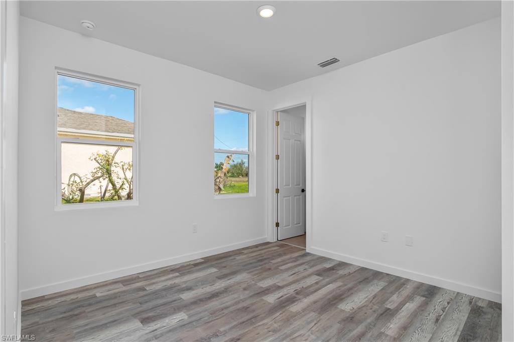1515 Nelson Road North Cape Coral, FL 33993 - Photo 27 of 38 a view of room with wooden floor and window