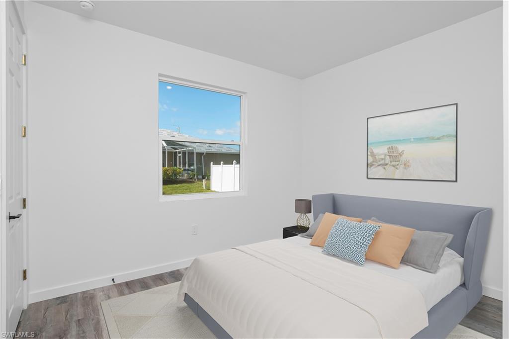 1515 Nelson Road North Cape Coral, FL 33993 - Photo 29 of 38 a bedroom with a bed and a window
