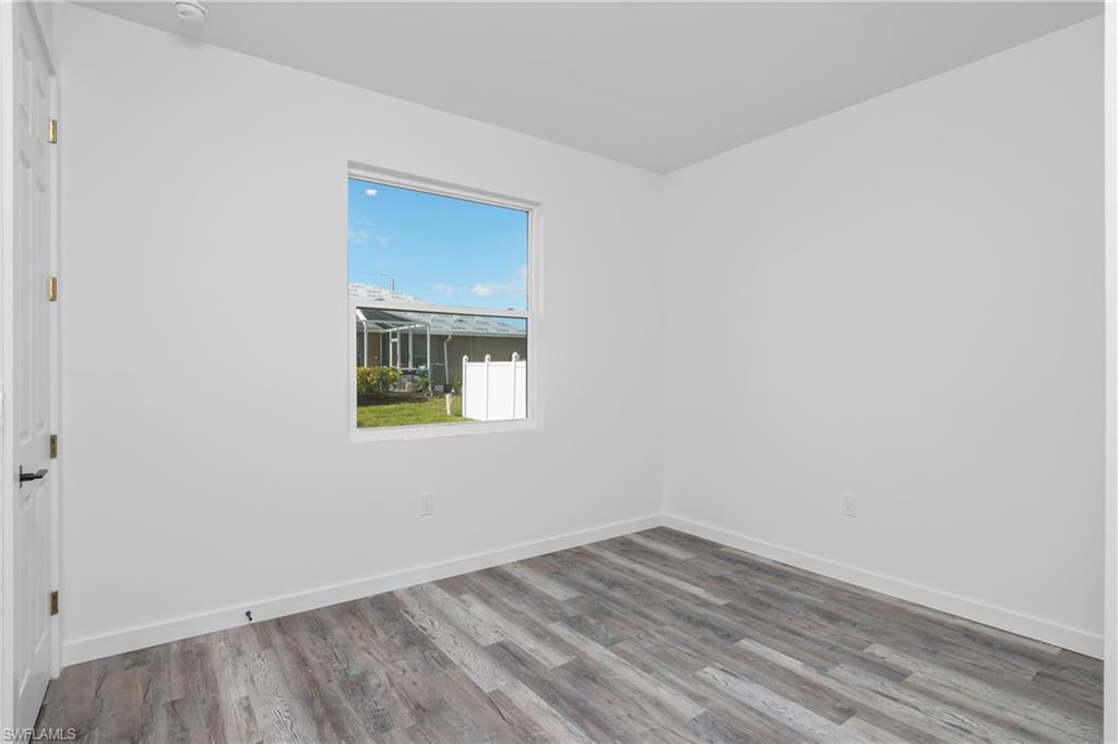 1515 Nelson Road North Cape Coral, FL 33993 - Photo 30 of 38 wooden floor in an empty room