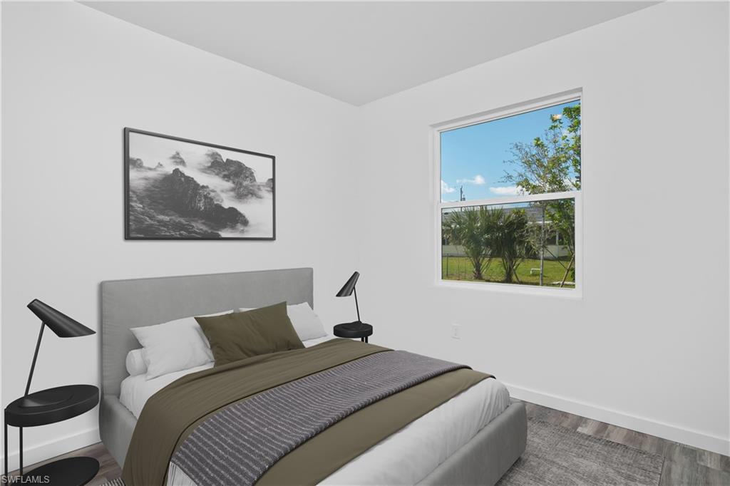 1515 Nelson Road North Cape Coral, FL 33993 - Photo 31 of 38 a bedroom with a bed and a painting on the wall