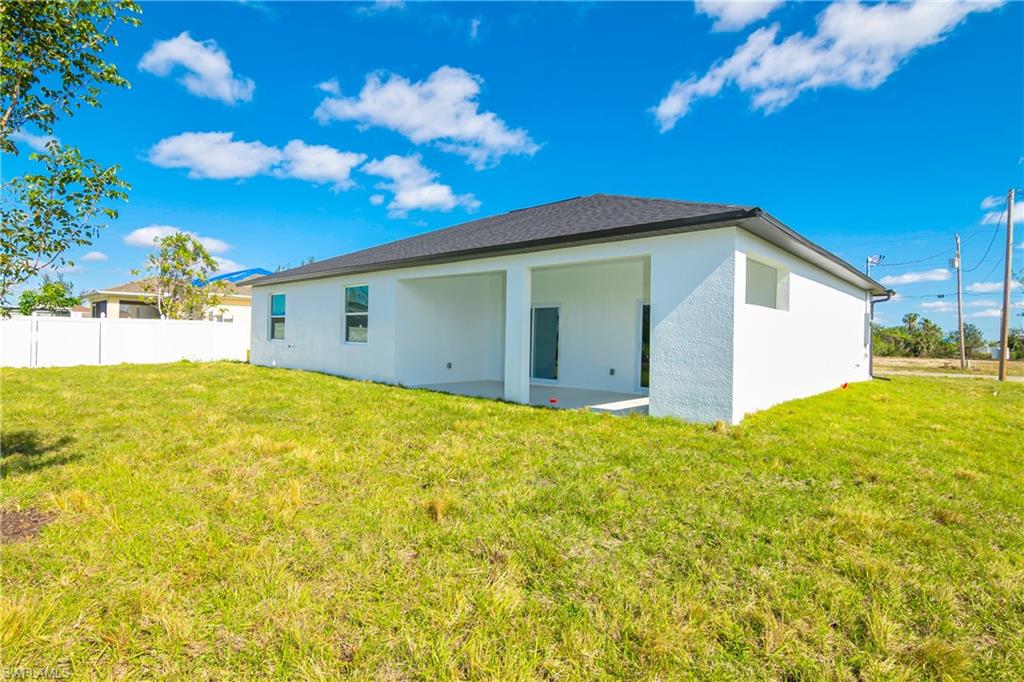 1515 Nelson Road North Cape Coral, FL 33993 - Photo 37 of 38 a view of yellow house with a backyard