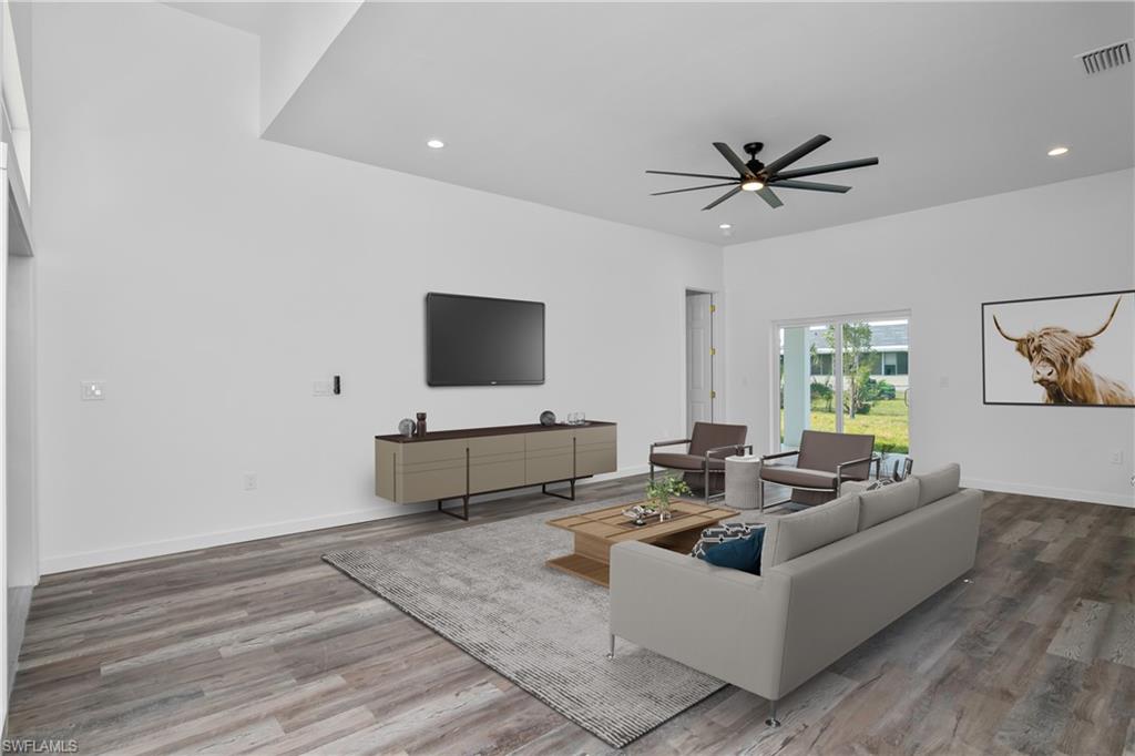1515 Nelson Road North Cape Coral, FL 33993 - Photo 6 of 38 a living room with furniture and a flat screen tv