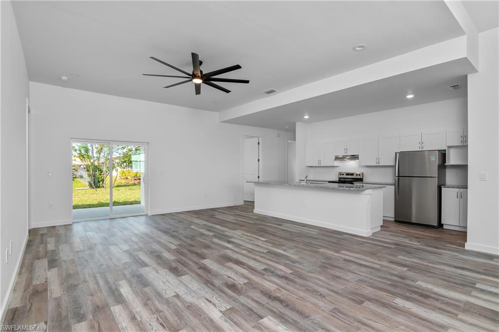 1515 Nelson Road North Cape Coral, FL 33993 - Photo 8 of 38 a view of kitchen with wooden floor electronic appliances and window