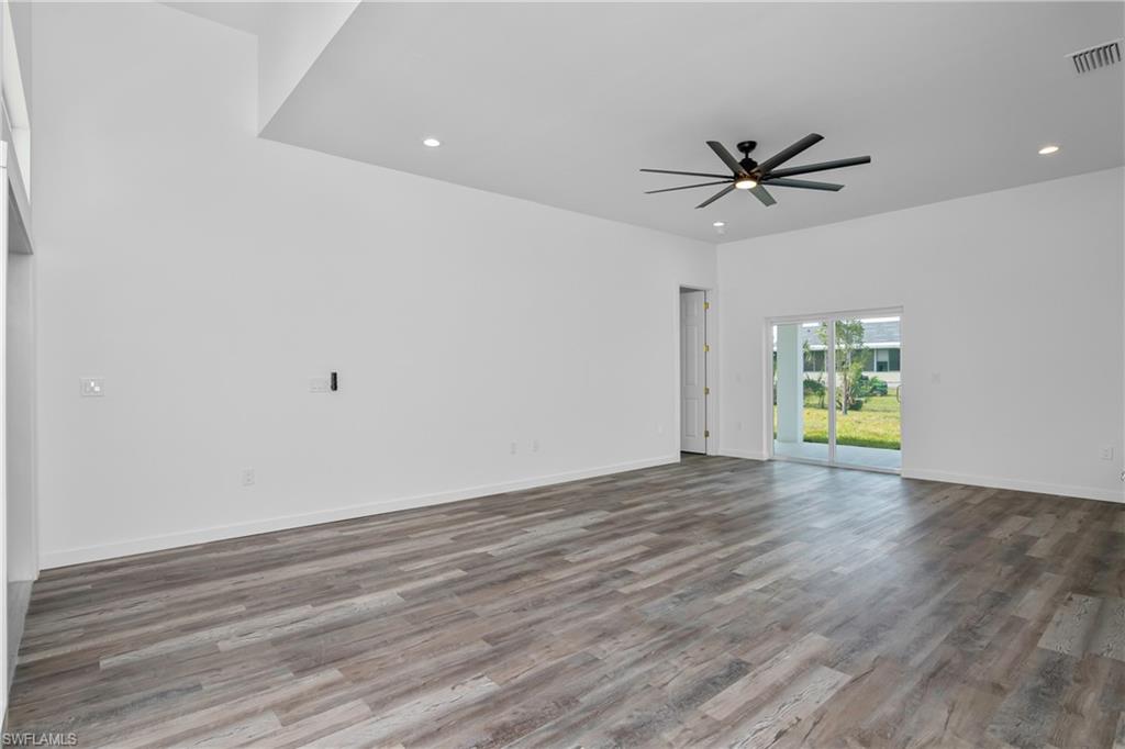 1515 Nelson Road North Cape Coral, FL 33993 - Photo 9 of 38 a view of empty room with wooden floor and fan