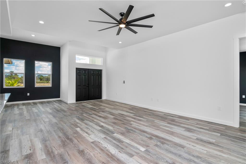 1515 Nelson Road North Cape Coral, FL 33993 - Photo 10 of 38 wooden floor in an empty room with a window