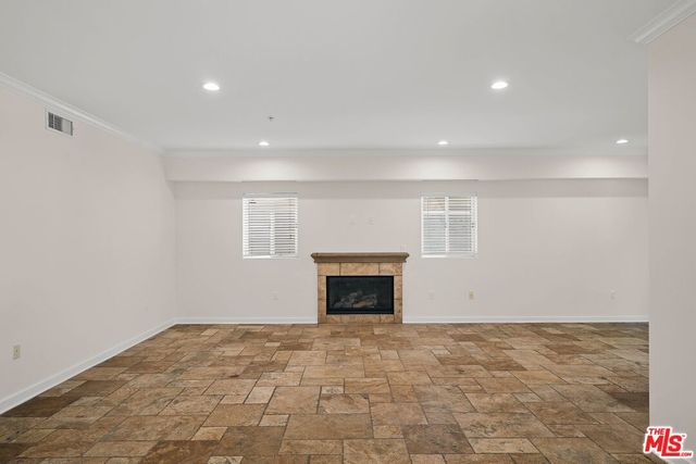a view of empty room with a fireplace