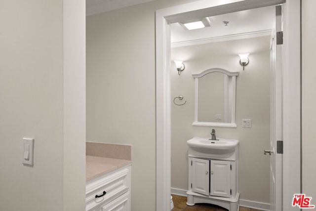 a bathroom with a sink a light fixture and a mirror