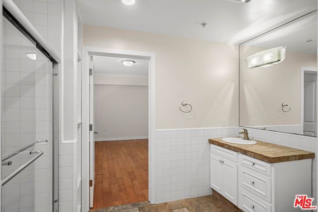 a bathroom with a granite countertop sink mirror and double