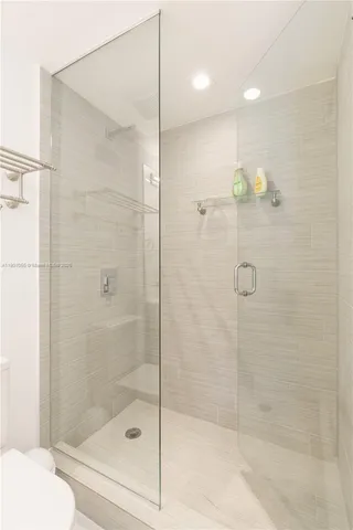 a bathroom with a shower and a toilet