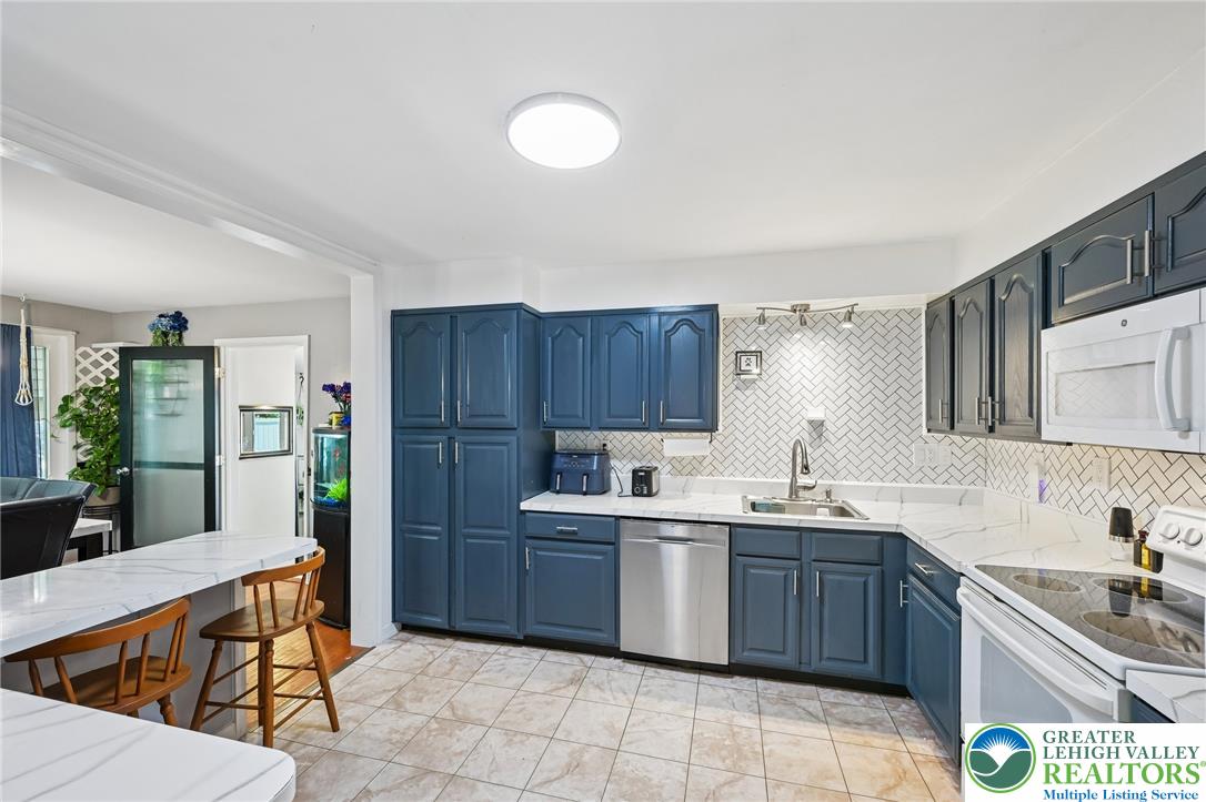 2649 Nottingham Road Bethlehem, PA 18017 - Photo 10 of 49 A well-appointed kitchen features blue cabinetry, white countertops, and stainless steel appliances.