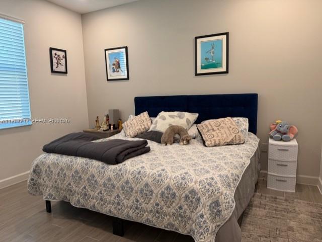 797 Bloomfield Road Port St. Lucie, FL 34984 - Photo 13 of 35 a bedroom with two beds and a painting on the wall