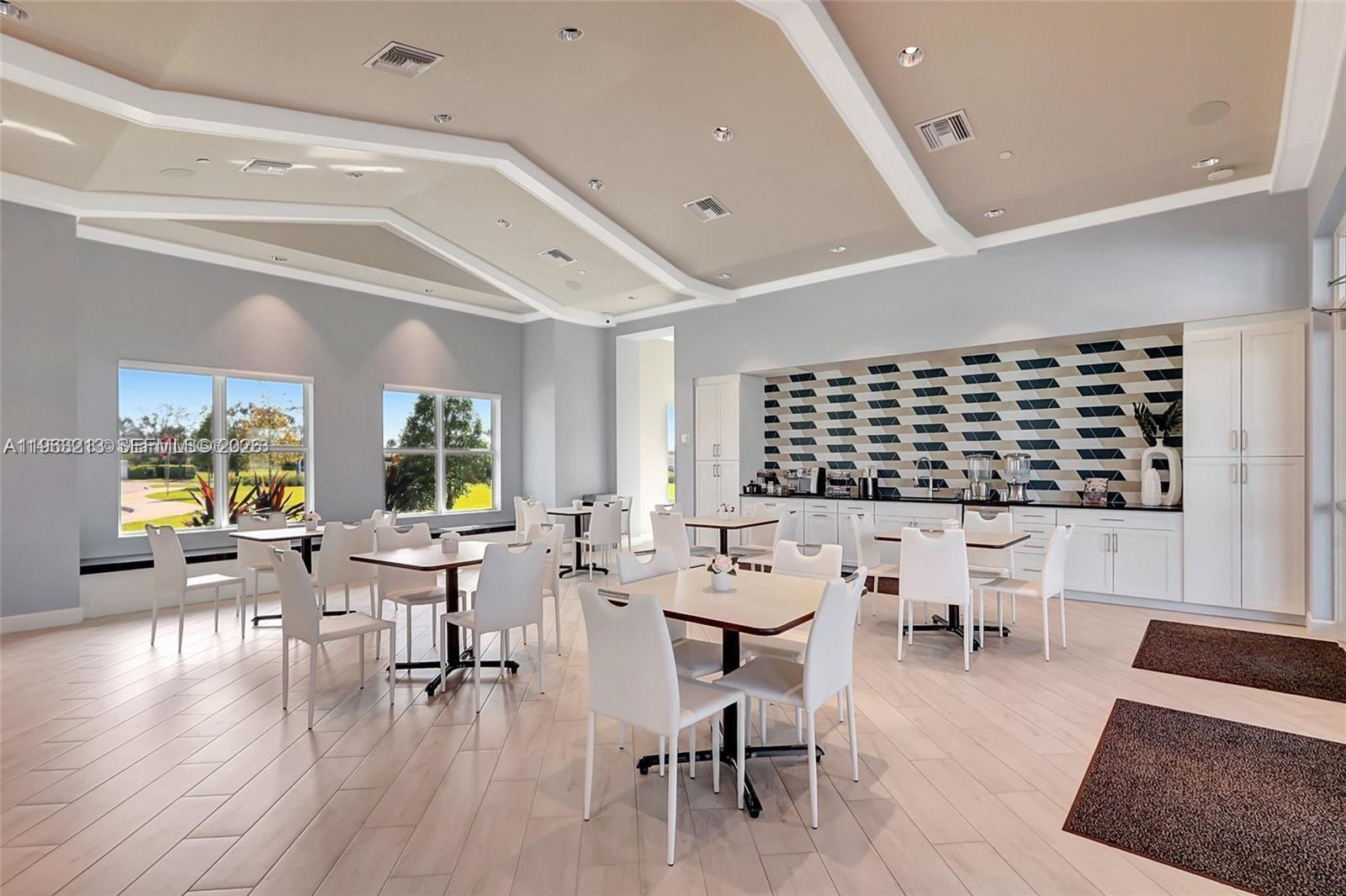 797 Bloomfield Road Port St. Lucie, FL 34984 - Photo 24 of 35 a living room with chairs and tables with wooden floor