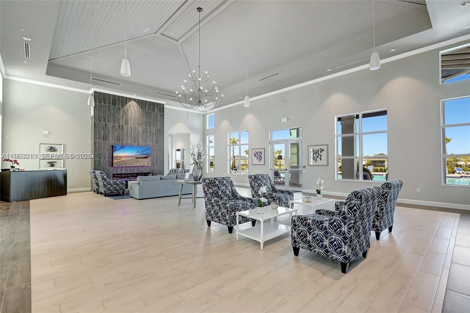 797 Bloomfield Road Port St. Lucie, FL 34984 - Photo 26 of 35 a living room with furniture and a chandelier