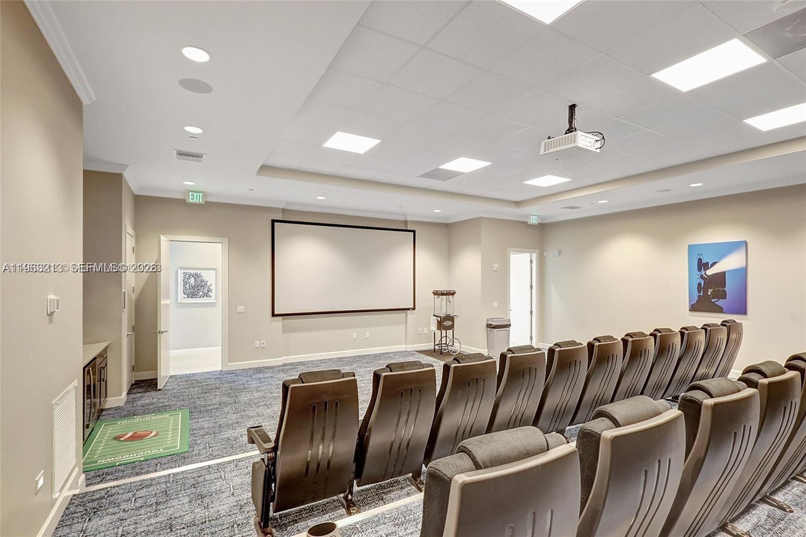 797 Bloomfield Road Port St. Lucie, FL 34984 - Photo 27 of 35 a media room with lots of chairs and a projector screen