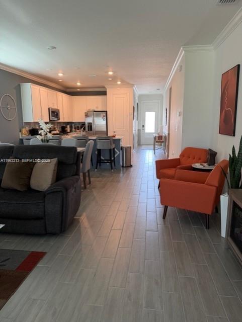 797 Bloomfield Road Port St. Lucie, FL 34984 - Photo 34 of 35 a living room with furniture and a wooden floor