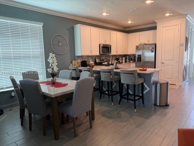 797 Bloomfield Road Port St. Lucie, FL 34984 - Photo 6 of 35 a view of a dining room with furniture window and wooden floor