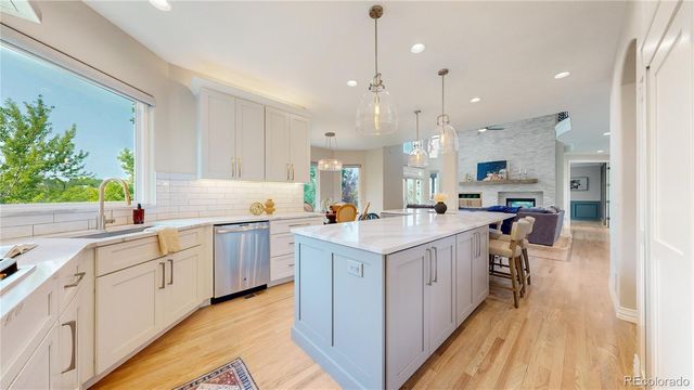 a kitchen with a sink window and stainless steel appliances