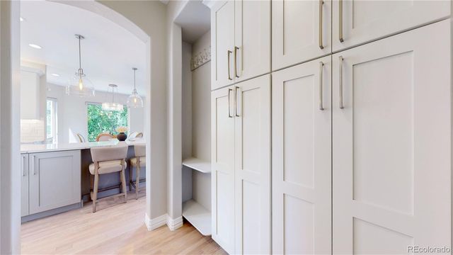 a view of a hallway with bathroom and wooden floor