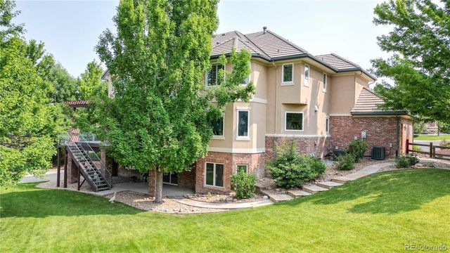 a house that has a tree in front of the house