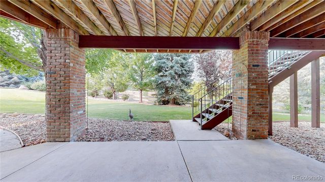 a view of a house with brick walls and a yard with plants