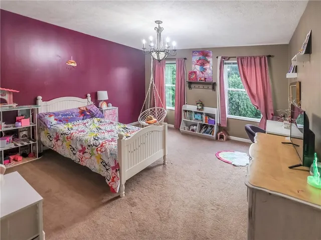 a bed room with furniture and a chandelier