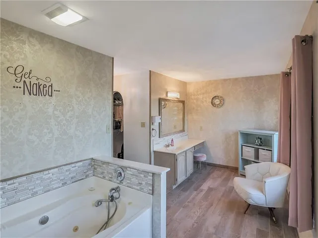 a bathroom with a tub sink and toilet