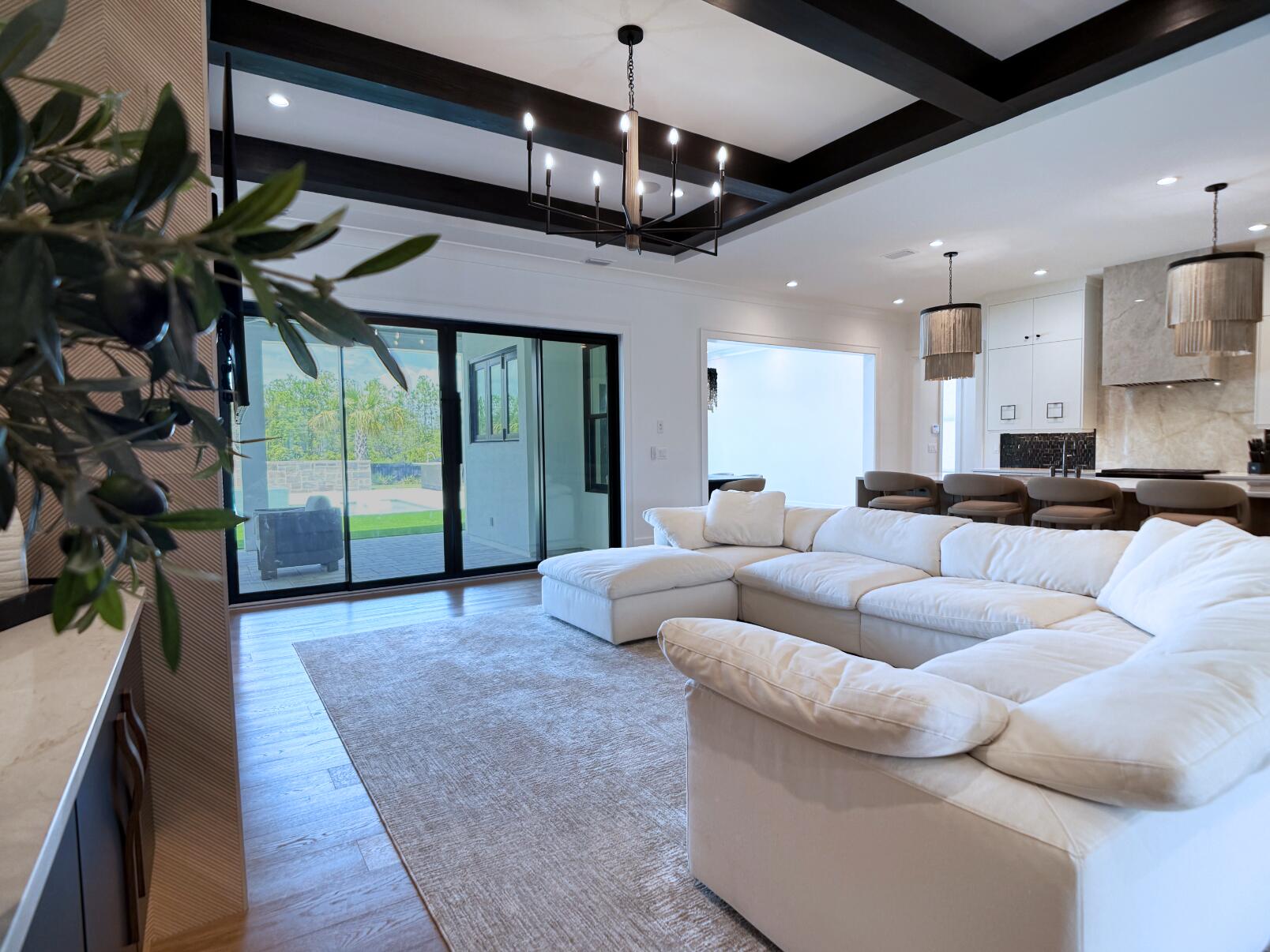 83 Norman Ct Inlet Beach Inlet Beach, FL 32461 - Photo 10 of 21 a living room with furniture a fireplace and a chandelier