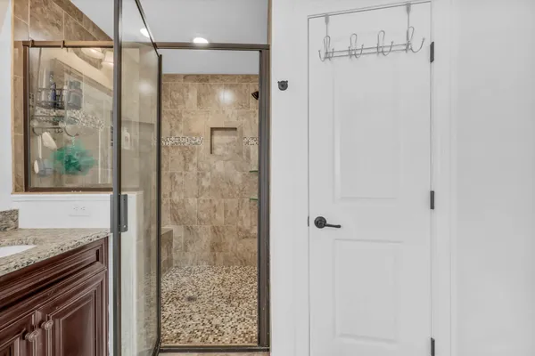 a bathroom with a granite countertop shower mirror and a sink