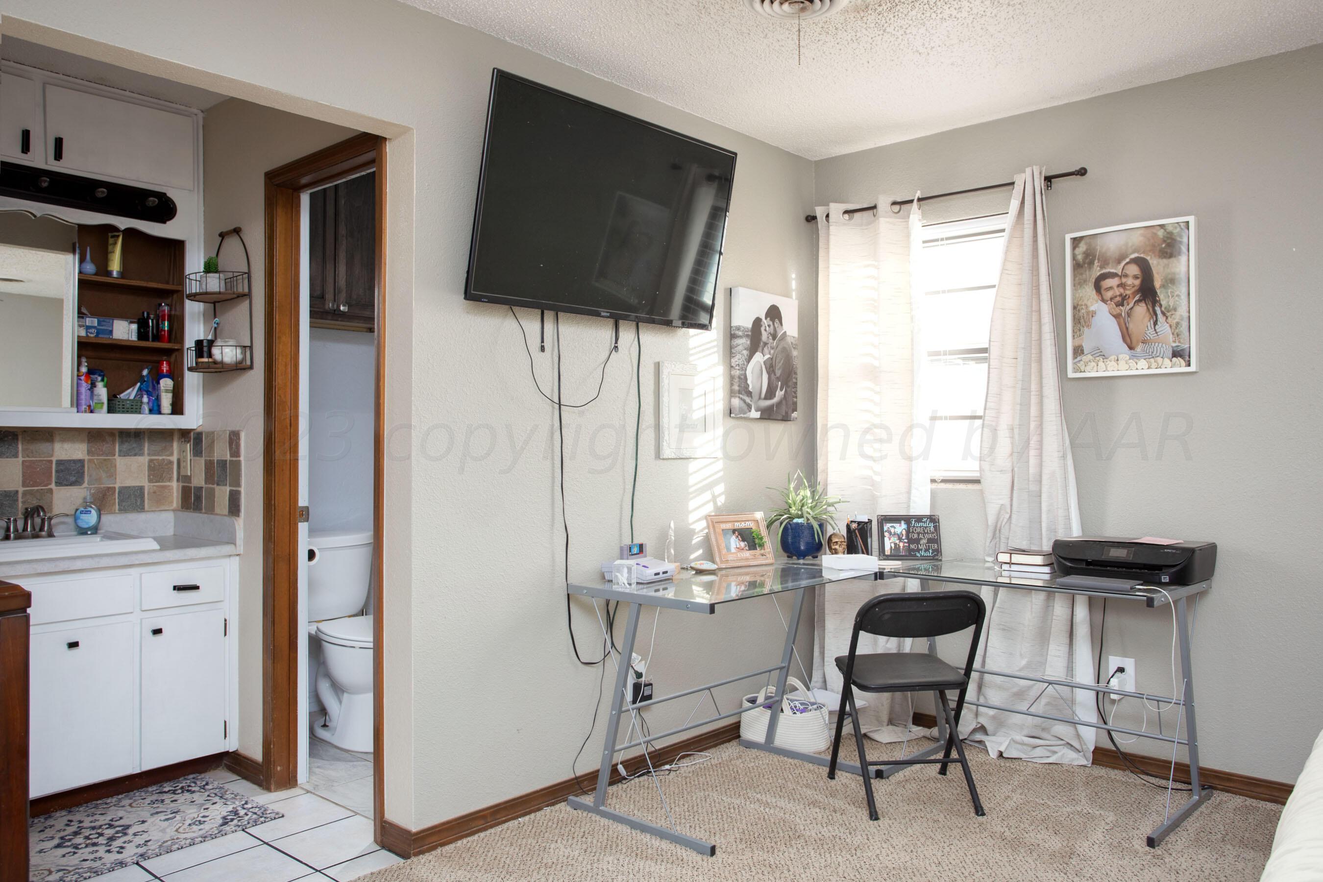 6101 Rutgers Street Amarillo, TX 79109 - Photo 14 of 24 a room with a couch and a flat screen tv