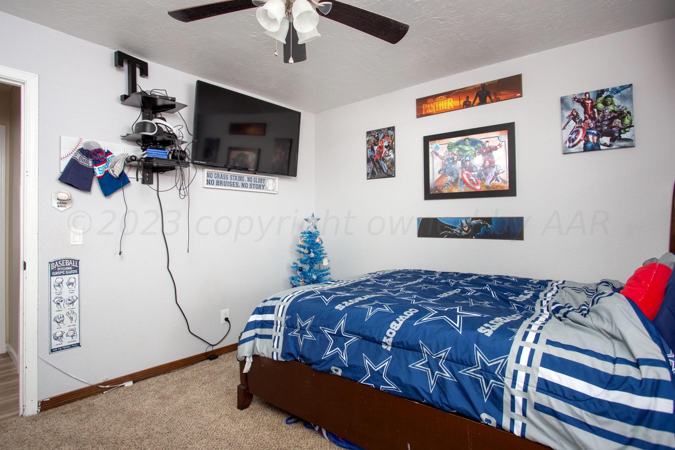 6101 Rutgers Street Amarillo, TX 79109 - Photo 23 of 24 a bedroom with a bed and a flat screen tv