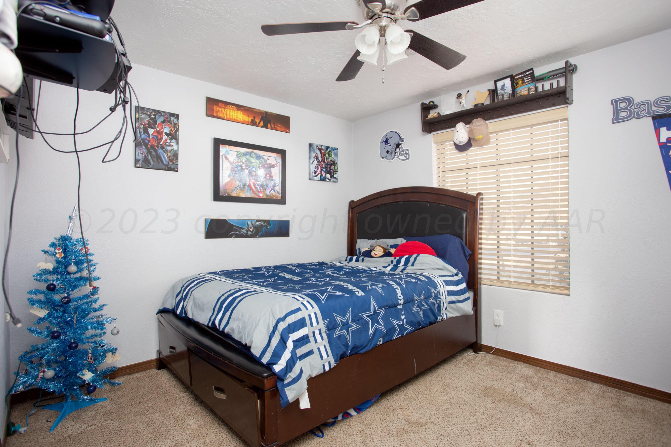 6101 Rutgers Street Amarillo, TX 79109 - Photo 24 of 24 a bedroom with a bed and a chandelier
