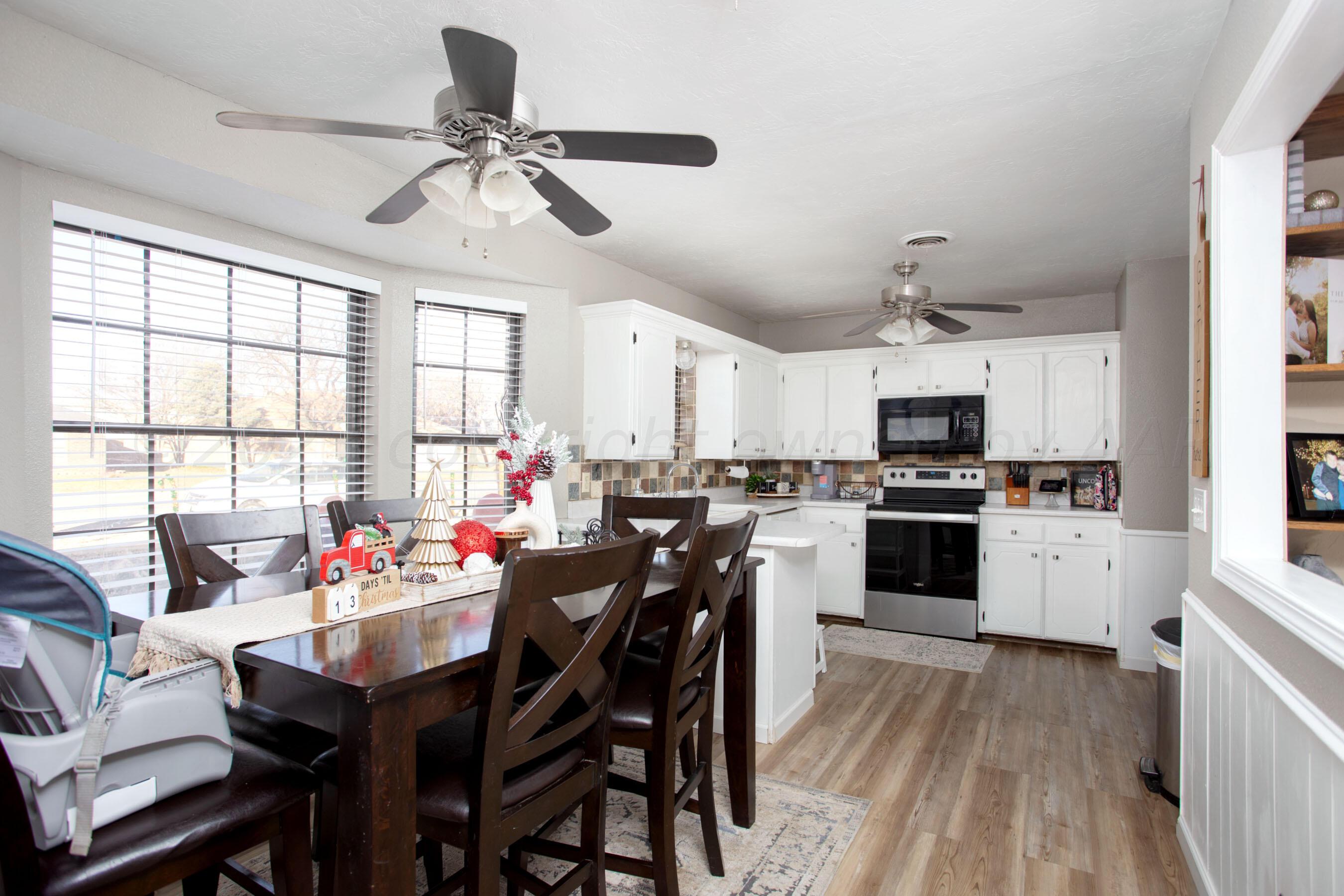 6101 Rutgers Street Amarillo, TX 79109 - Photo 5 of 24 a kitchen with a dining table chairs appliances and cabinets