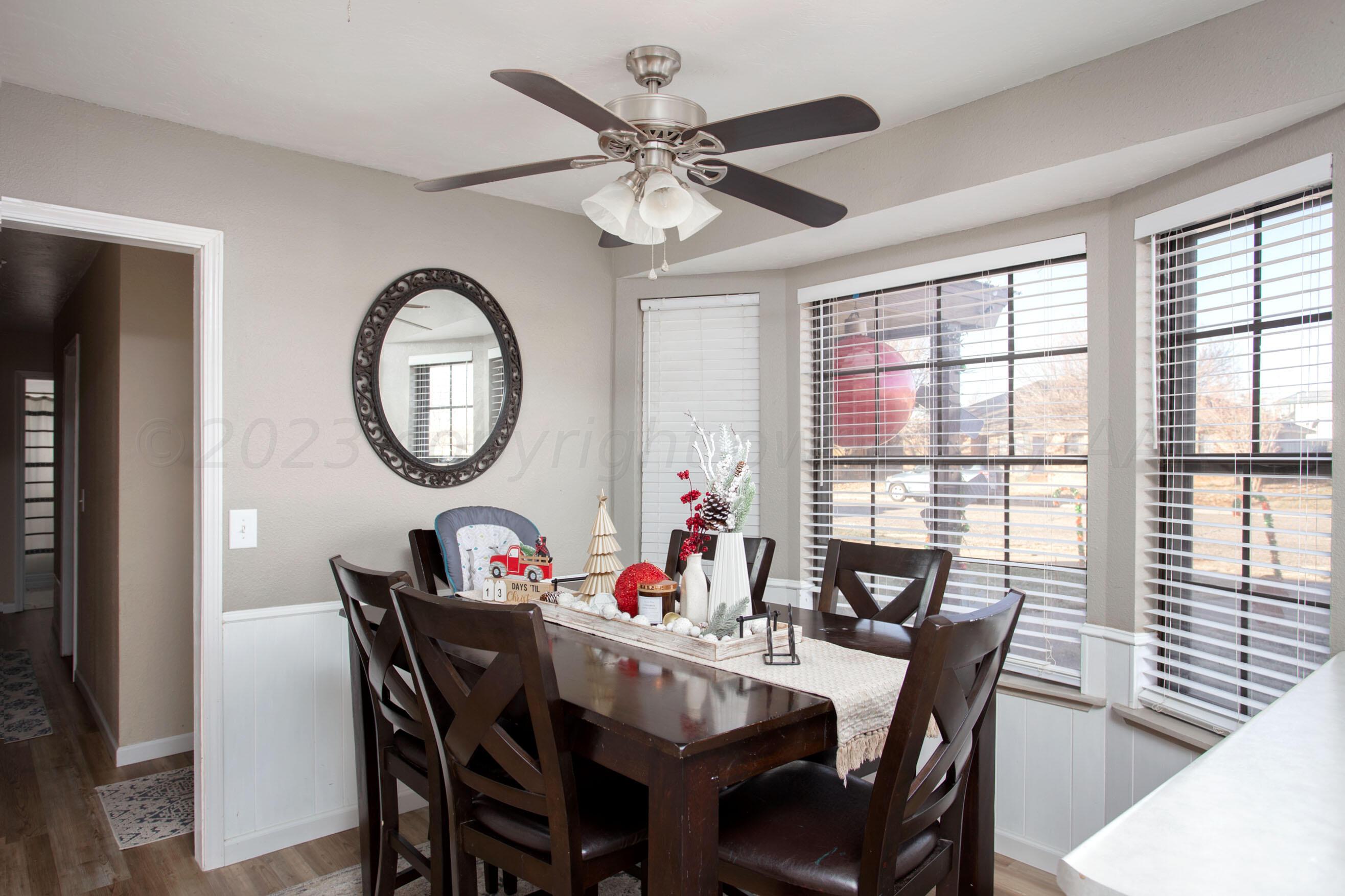6101 Rutgers Street Amarillo, TX 79109 - Photo 6 of 24 a dining room with furniture a window and a mirror