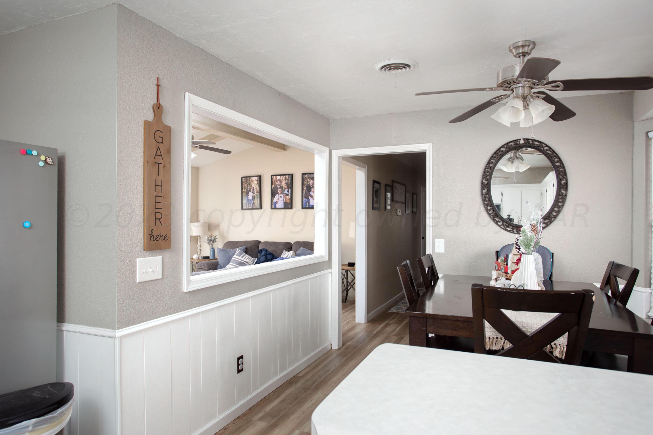 6101 Rutgers Street Amarillo, TX 79109 - Photo 8 of 24 a living room with furniture a mirror and a window