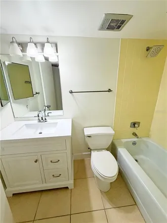 a bathroom with a sink mirror vanity and toilet