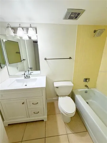 a bathroom with a sink mirror vanity and toilet