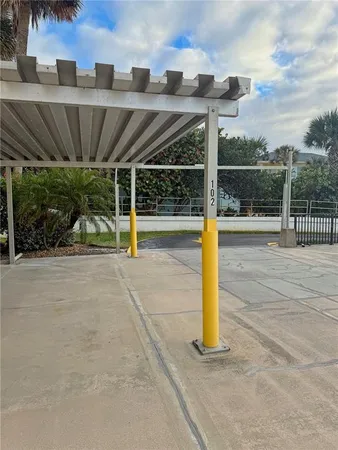 a view of a house with a small yard and wooden fence