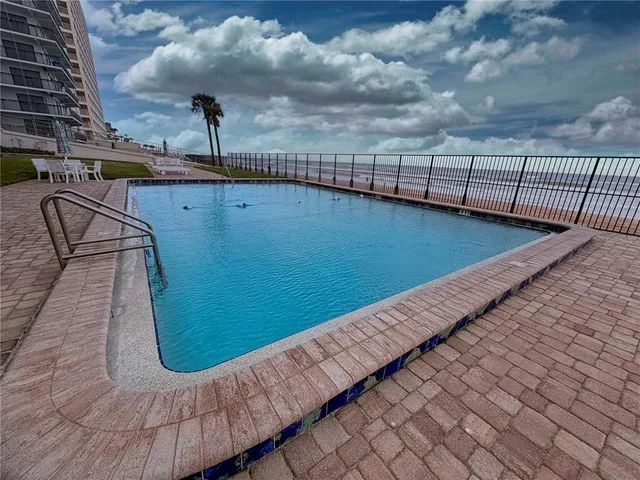 a view of a swimming pool with a yard