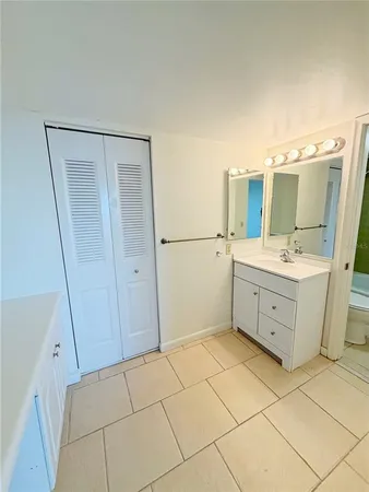 a bathroom with a sink a mirror and a shower