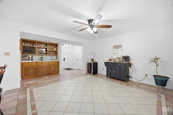 a view of kitchen with granite countertop cabinets and window
