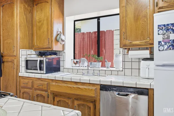 a kitchen with stainless steel appliances granite countertop a sink and a stove