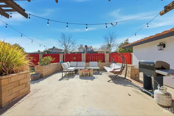 a view of a patio with a table and chairs