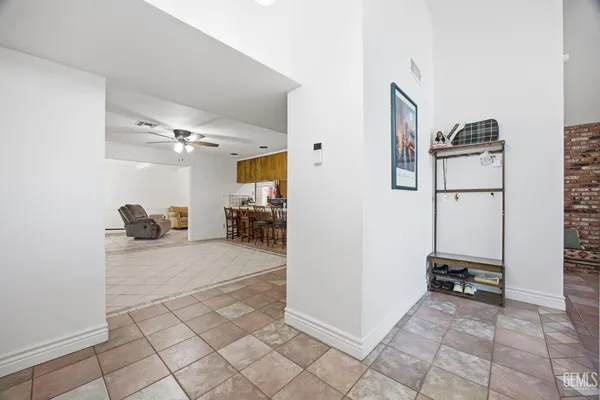 a view of a kitchen with a refrigerator and a stove top oven
