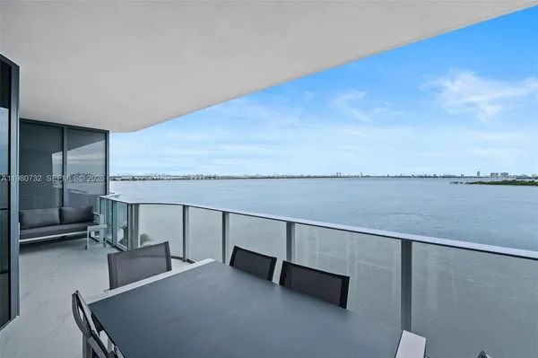 a balcony with an outdoor seating